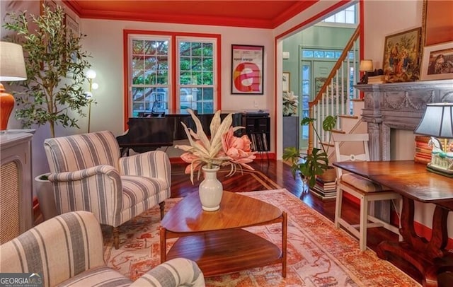 sitting room featuring stairs, wood finished floors, and crown molding