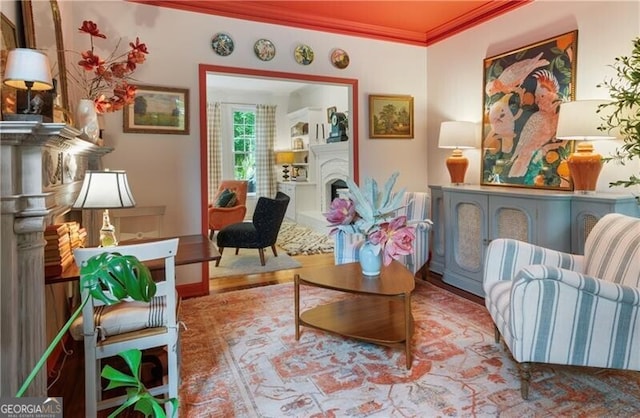 living area featuring ornamental molding and a fireplace