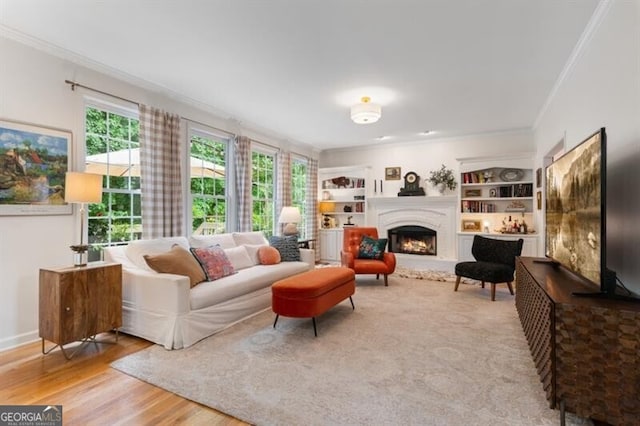 living room featuring ornamental molding, a lit fireplace, and wood finished floors