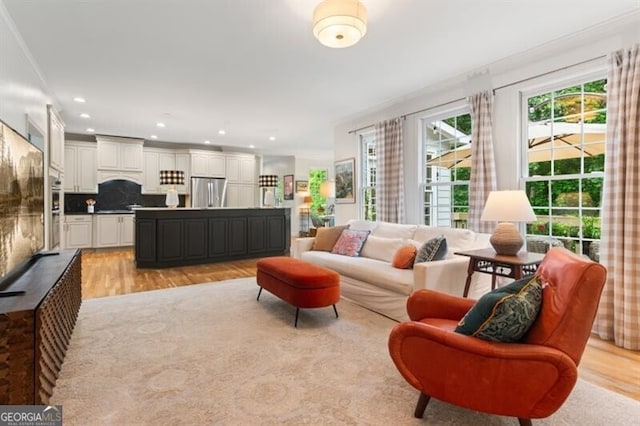 living area featuring light wood-style flooring and recessed lighting