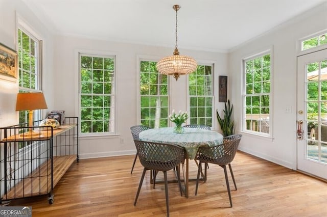 sunroom featuring a chandelier