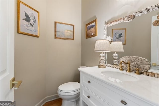 half bathroom with toilet and vanity