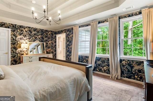 carpeted bedroom with wallpapered walls, ornamental molding, a chandelier, a tray ceiling, and baseboards