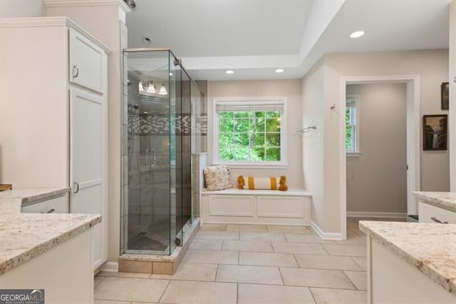 bathroom with a stall shower, recessed lighting, tile patterned flooring, baseboards, and vanity