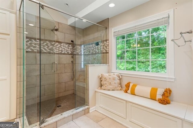 bathroom featuring a shower stall, healthy amount of natural light, and tile patterned flooring