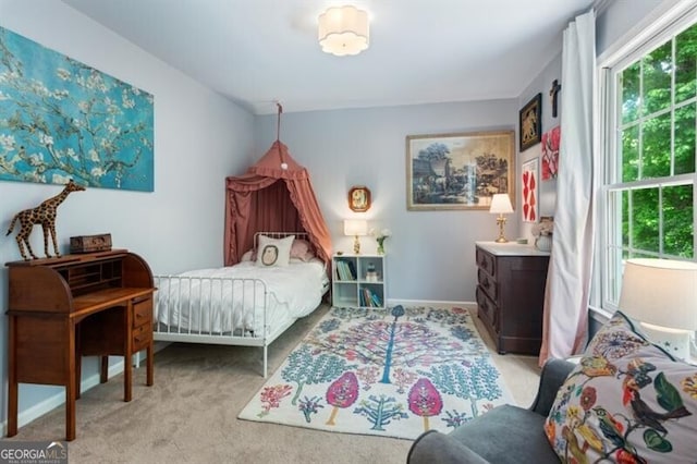 carpeted bedroom featuring baseboards