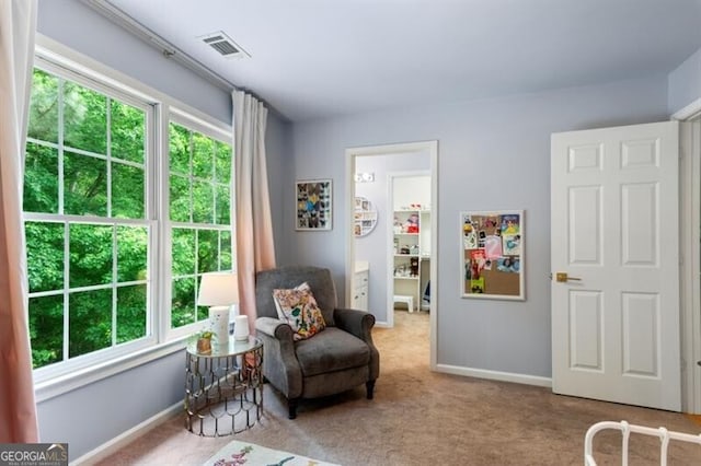 sitting room with carpet and baseboards