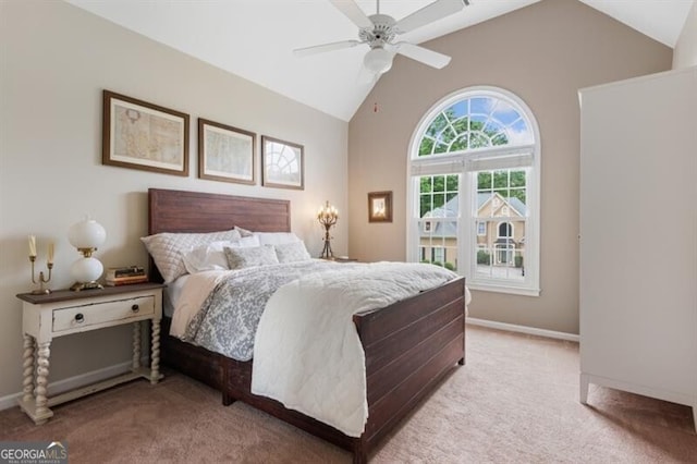 bedroom featuring light colored carpet, baseboards, high vaulted ceiling, and ceiling fan