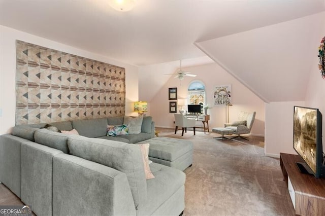 carpeted living area featuring ceiling fan, vaulted ceiling, and baseboards