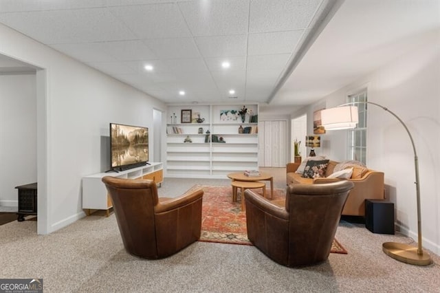 carpeted living room with recessed lighting and baseboards