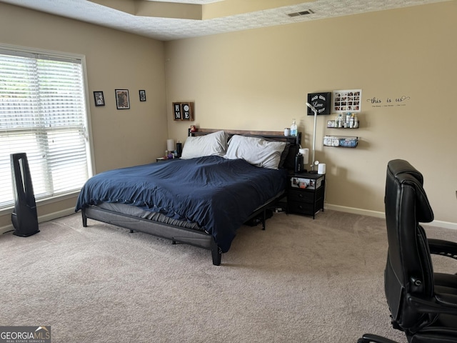 carpeted bedroom with baseboards and visible vents