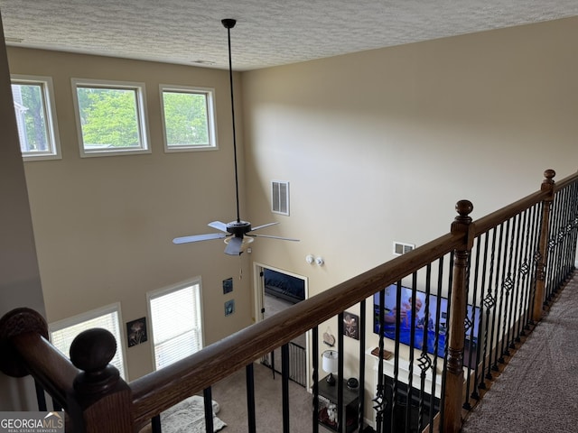 interior details featuring carpet floors, a textured ceiling, and visible vents