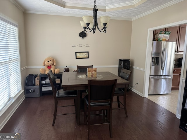 dining room featuring an inviting chandelier, plenty of natural light, and hardwood / wood-style flooring