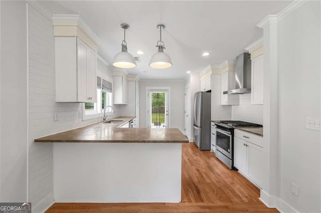 1798 S Gordon St SW, Atlanta, GA 30310 - kitchen with a sink, crown molding, backsplash, wall chimney range hood, and appliances with stainless steel finishes
