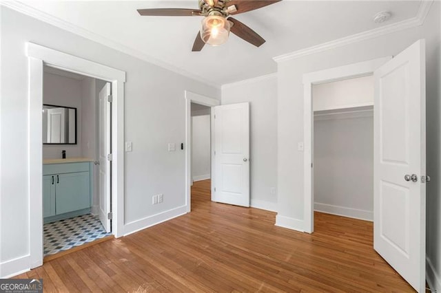 1798 S Gordon St SW, Atlanta, GA 30310 - unfurnished bedroom with baseboards, a spacious closet, crown molding, and wood finished floors