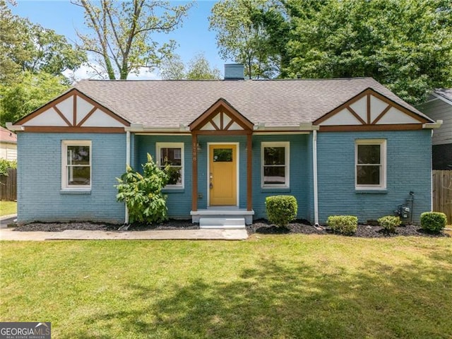 1798 S Gordon St SW, Atlanta, GA 30310 - view of front of house featuring fence, brick siding, a front lawn, a chimney, and a shingled roof