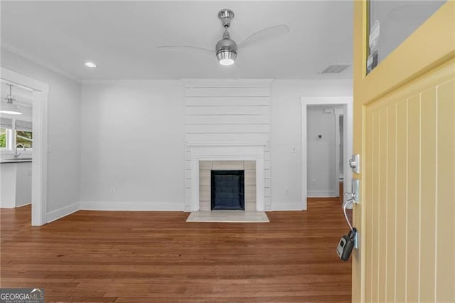1798 S Gordon St SW, Atlanta, GA 30310 - unfurnished living room featuring wood finished floors, a ceiling fan, baseboards, a fireplace with raised hearth, and ornamental molding