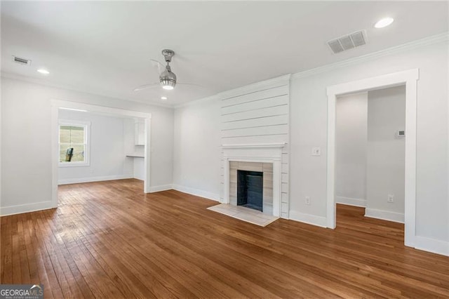 1798 S Gordon St SW, Atlanta, GA 30310 - unfurnished living room with a tile fireplace, visible vents, a ceiling fan, and hardwood / wood-style floors
