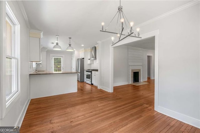 1798 S Gordon St SW, Atlanta, GA 30310 - unfurnished dining area with a sink, light wood-type flooring, crown molding, a chandelier, and baseboards