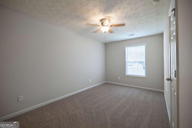 unfurnished room featuring carpet floors, a ceiling fan, a textured ceiling, and baseboards