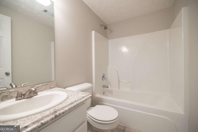 bathroom with vanity, visible vents, toilet, a textured ceiling, and shower / washtub combination