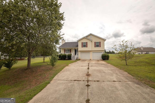 tri-level home featuring a garage, a front lawn, driveway, and a chimney
