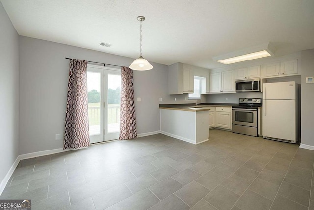 kitchen featuring appliances with stainless steel finishes, baseboards, and a wealth of natural light