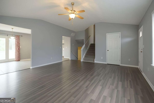 unfurnished living room with wood finished floors, a ceiling fan, lofted ceiling, and stairway