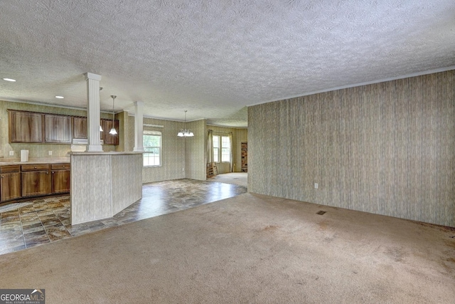 unfurnished living room featuring carpet flooring, a textured ceiling, and a chandelier