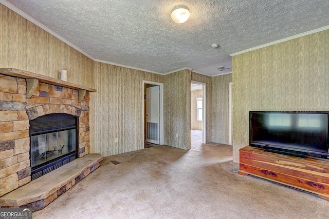 unfurnished living room featuring ornamental molding, carpet, a textured ceiling, and a fireplace