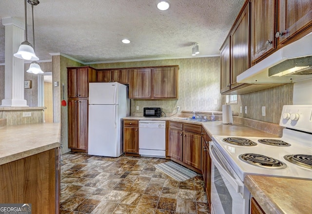 kitchen with ornamental molding, white appliances, a textured ceiling, under cabinet range hood, and a sink