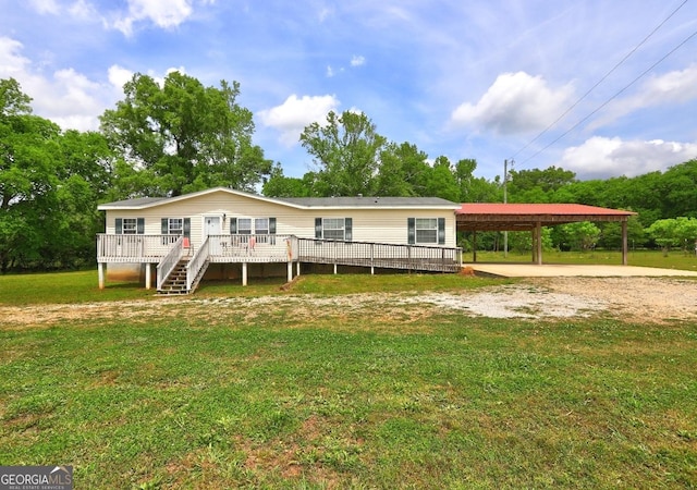 back of property with stairway, a wooden deck, a yard, and driveway