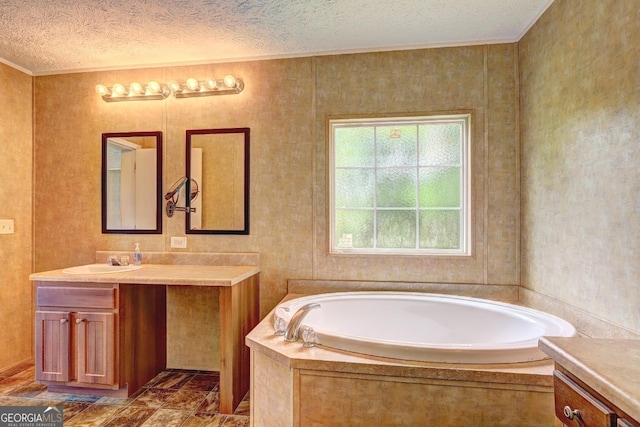 bathroom featuring crown molding, a textured ceiling, a bath, and vanity