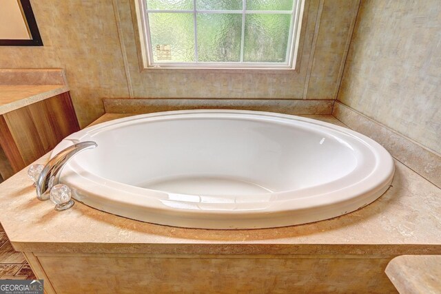 full bath with vanity and a bath