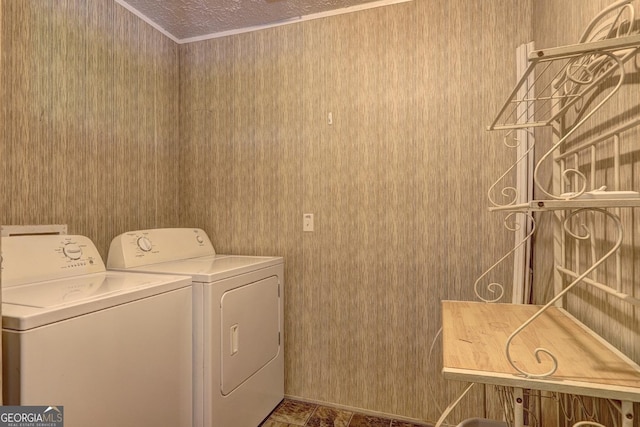 washroom featuring washing machine and clothes dryer, laundry area, and wallpapered walls