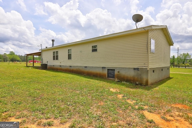rear view of property with central AC, a yard, and crawl space