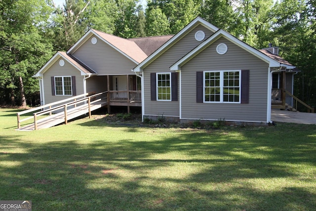 view of front of property featuring covered porch and a front yard