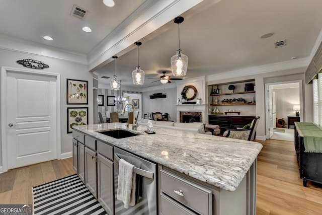 kitchen with ceiling fan, a sink, a fireplace, dishwasher, and visible vents