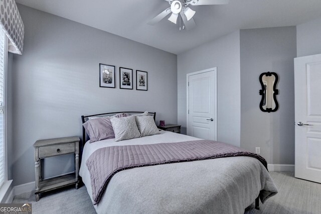 carpeted bedroom featuring baseboards and ceiling fan