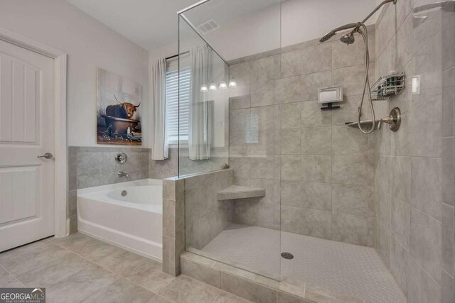 full bath featuring tile patterned flooring, visible vents, tiled shower, and a bath
