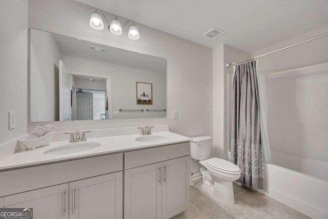 bathroom with toilet, visible vents, and a sink