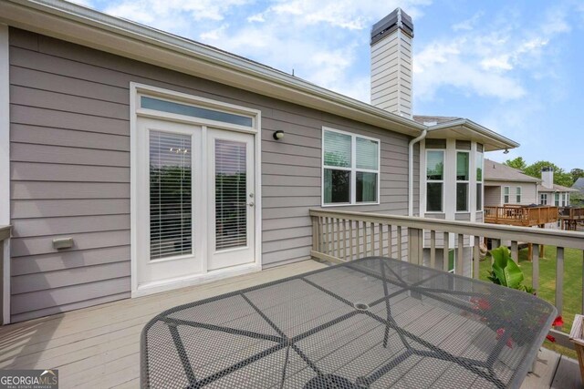 wooden deck featuring outdoor dining area
