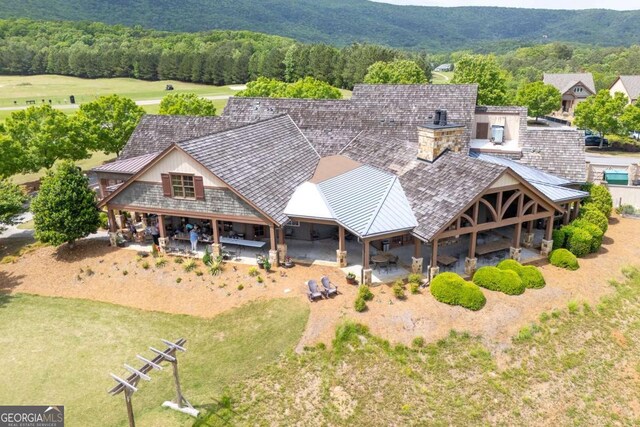 birds eye view of property with a mountain view and a wooded view