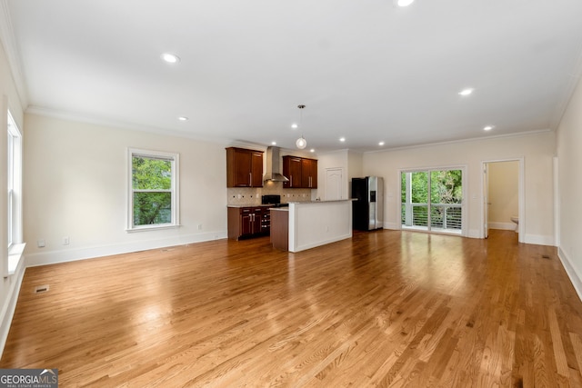 1303 N Druid Hills Rd, Brookhaven, GA 30319 - unfurnished living room featuring baseboards, ornamental molding, and a healthy amount of sunlight