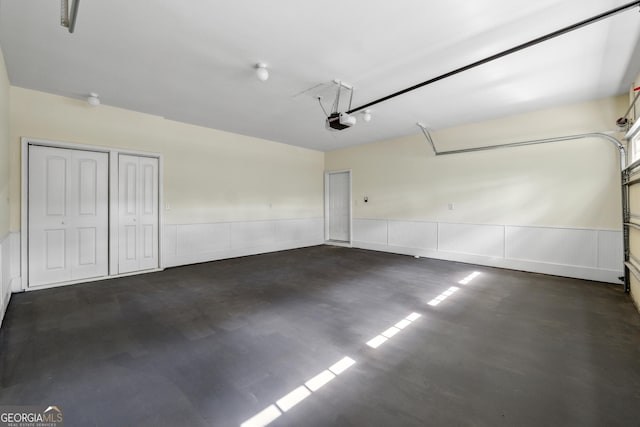 1303 N Druid Hills Rd, Brookhaven, GA 30319 - garage with a garage door opener and a wainscoted wall
