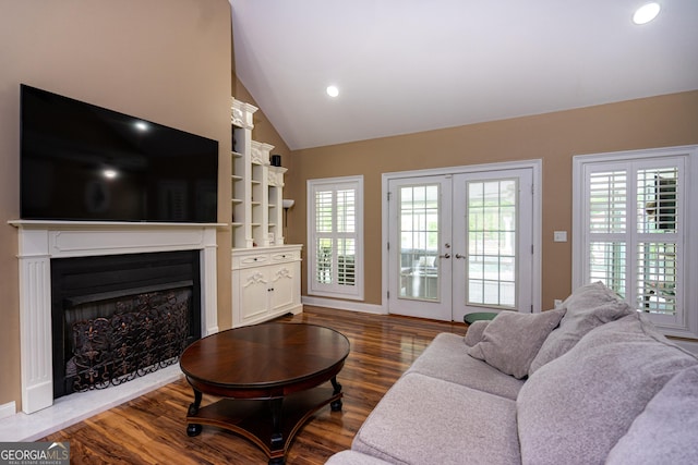 living room with a fireplace, french doors, recessed lighting, wood finished floors, and lofted ceiling