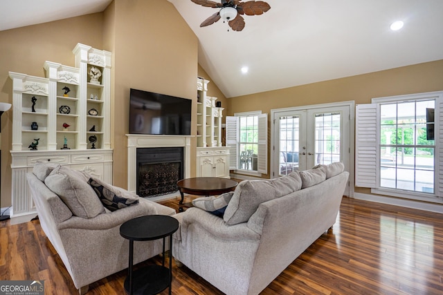 living area with a fireplace, ceiling fan, dark wood-style floors, plenty of natural light, and french doors
