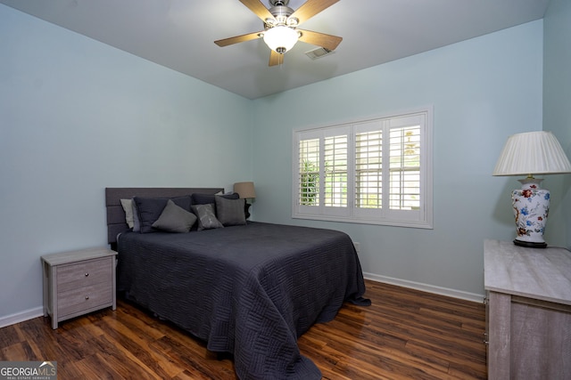 bedroom featuring baseboards, a ceiling fan, wood finished floors, and visible vents