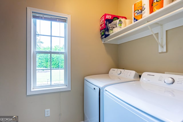 laundry area with laundry area, independent washer and dryer, and a healthy amount of sunlight
