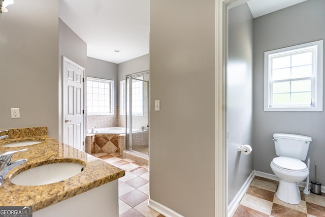 bathroom with tile patterned flooring, a sink, and a healthy amount of sunlight